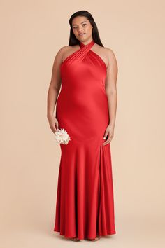 a woman in a red dress posing for the camera with her hands on her hips