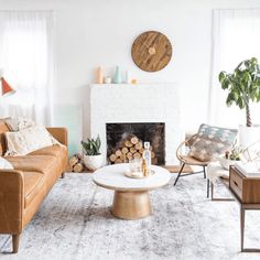 a living room filled with furniture and a fire place in front of a white fireplace