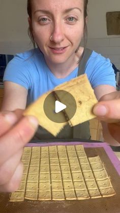 a woman holding up a piece of bread