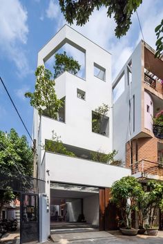 the house is white and has two stories on each level that are connected to one another