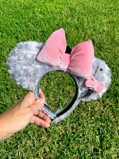 "Oh bother ... if you're a Winnie the Pooh fan and Eeyore pulls at your heartstrings the way he does to us, then these ears are for you! Made from a shimmery grey fluffy material and accessorized with a velvet pink bow, Eeyore's attachable tail, and a tuft of his hair on the back of the bow, these ears are perfect for hanging out in the Hundred Acre Woods! The headband is stitched with a non-slip velour so you ears will remain both comfortable and secure as you're off to fight heffalumps and woo Eeyore Disneybound, Disney Ears Hat, Ear Ideas, Diy Disney Ears, Disneyland Ears, Diy Mickey Ears, Disney Bows, Disney Mickey Ears, Disney Merch