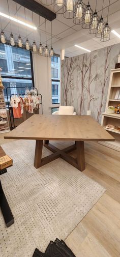 a large wooden table sitting in the middle of a room next to a book shelf