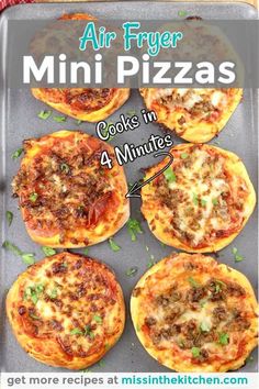 four mini pizzas on a baking sheet with the title air fryer mini pizzas cook in 4 minutes