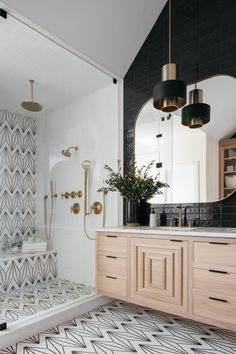 a modern bathroom with black and white tiles