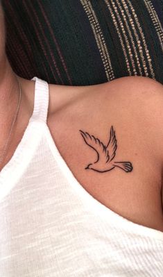 a woman with a small tattoo on her chest