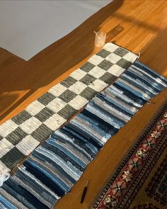 the rugs are laid out on the floor to be used as a table runner