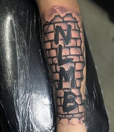 a man's arm with graffiti on it and the word love me written in black ink