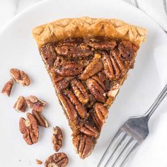 a slice of pecan pie on a plate with a fork