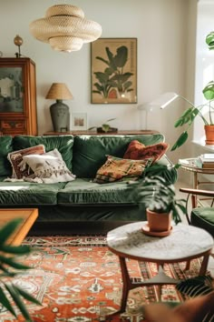 a living room with green couches and plants on the table in front of it