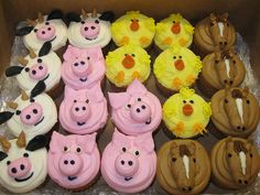 a box filled with lots of cupcakes shaped like pigs and chickens sitting on top of each other