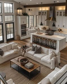 a living room filled with furniture and lots of windows