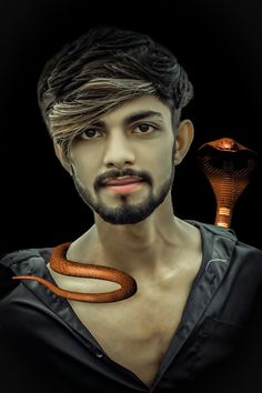 a man with a snake on his neck and an orange snake around his neck, against a black background