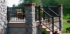 an outdoor patio with stone walls and stairs