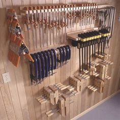 there is a rack with many pairs of skis hanging on the wall