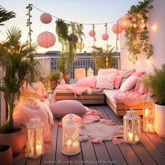 a balcony with lots of lights and pillows on the floor next to potted plants