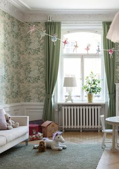 a living room filled with furniture and a window covered in green curtained drapes