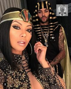 a man and woman dressed up in egyptian garb posing for the camera with an egyptian headdress on