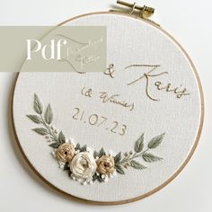 a wedding embroidered onto a hoop with flowers