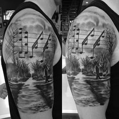 a man's half sleeve with musical notes on the water and trees in the background