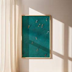 an aerial view of people swimming in the ocean from above, framed in gold and green