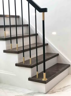 a set of stairs with black and gold railings