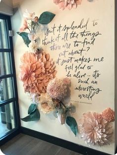 a wall with flowers on it and a poem written in cursive writing above the flowers