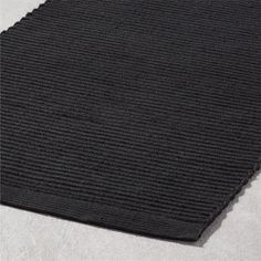 a black rug is laying on the floor