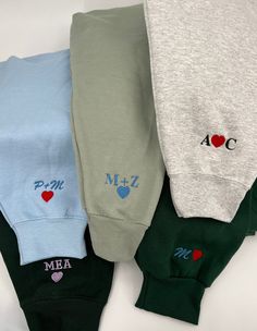 three pairs of sweatpants with hearts and the word mea written on them are lined up next to each other