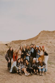 a group of women posing for a photo in the desert