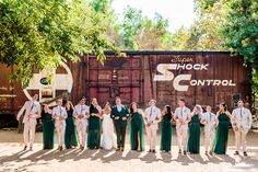 a group of people standing next to each other in front of a train car with the words shock control on it