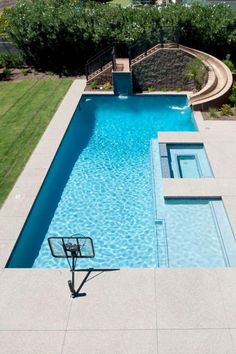 an aerial view of a swimming pool in a backyard