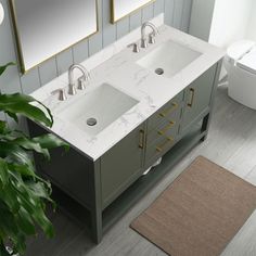 a bathroom with two sinks and mirrors on the wall next to a rug in front of it