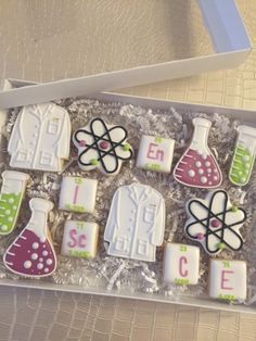 a box filled with decorated cookies sitting on top of a table