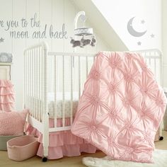 a baby crib bedding set with pink ruffles