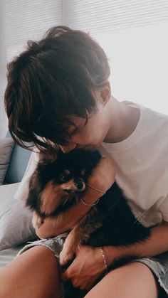 a woman holding a small dog in her lap with the words happy new year written on it