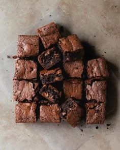 a pile of brownies sitting on top of a table