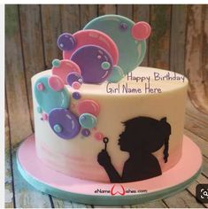 a birthday cake with a girl blowing bubbles on it