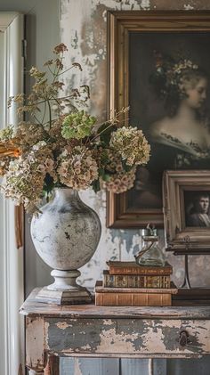 a vase filled with flowers sitting on top of a table next to an old book