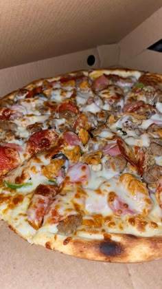 a pizza sitting inside of a box on top of a table