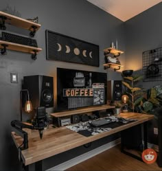 a computer desk topped with lots of computers and sound equipment on top of a wooden table