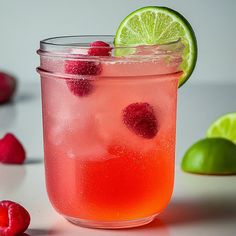 a glass filled with raspberry lemonade and lime