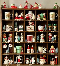 a wooden shelf filled with lots of christmas figurines