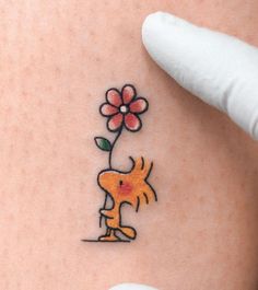 a person with a flower tattoo on their stomach