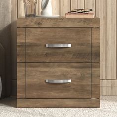 a wooden dresser with two drawers next to a chair and vase on the side table