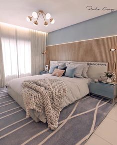 a bedroom with a large bed and blue walls