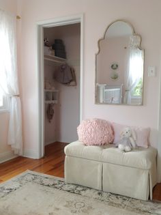 a white bench sitting in front of a mirror