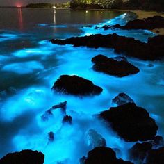 some rocks and water at night time