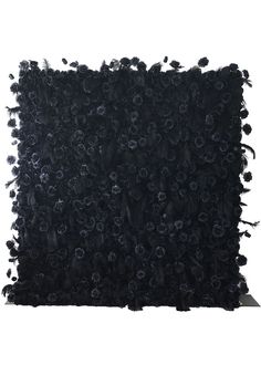 a black square rug with flowers on the front and back, all in different sizes