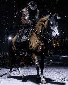 a man riding on the back of a brown horse next to a snow covered ground