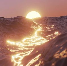 the sun is setting over an ocean wave as seen from the water's surface